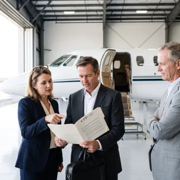 Business leaders reviewing private jet financing