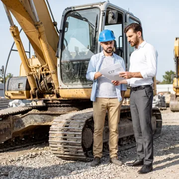 Construction manager reviewing excavator financing plans
