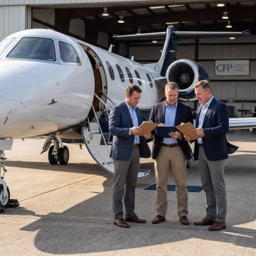 Business aircraft parked at an airport hangar