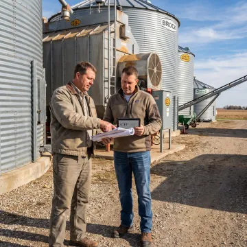 Agricultural manager reviewing grain dryer financing plans