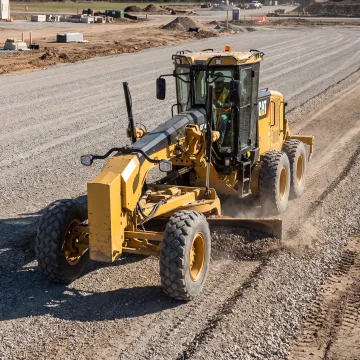 Motor grader leveling a construction site