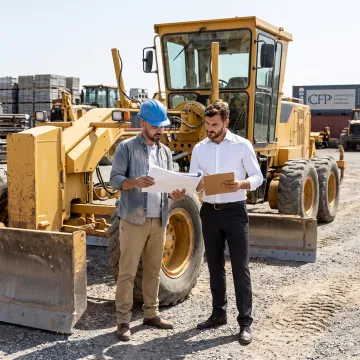 Construction manager reviewing motor grader financing