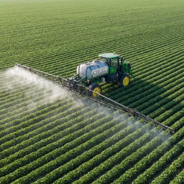 Self-propelled sprayer operating across a farm field