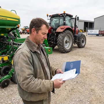 Farm manager reviewing planter financing plans