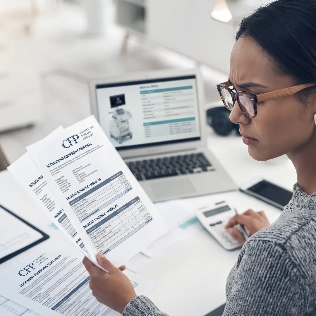 Healthcare administrator reviewing ultrasound financing documents
