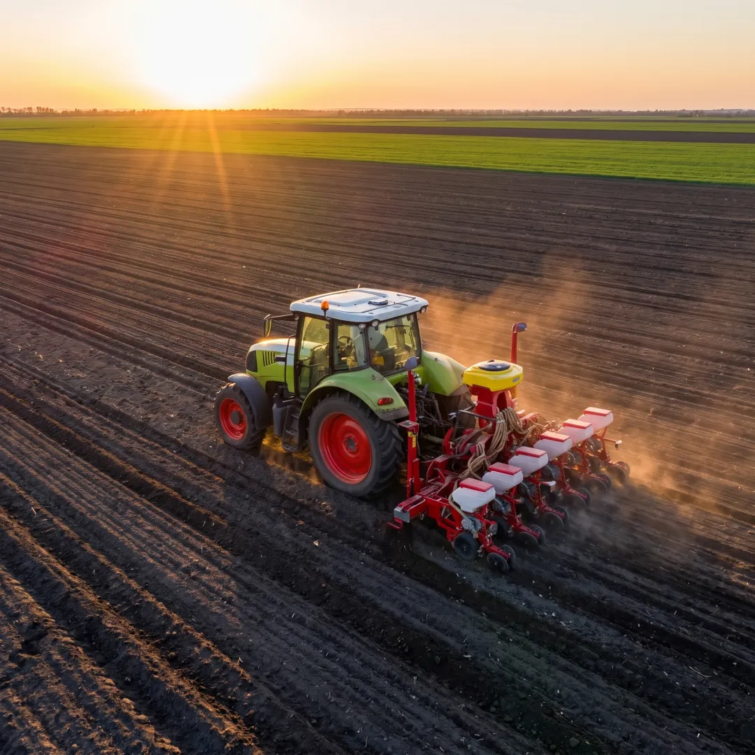 Modern tractor working in a cultivated field