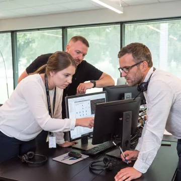 IT support colleagues discussing a customer issue