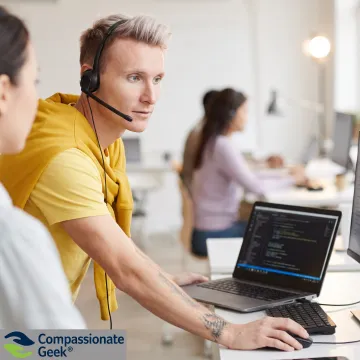 IT support professional calmly assisting a frustrated coworker