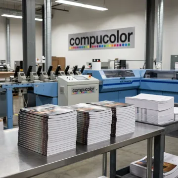 Finished perfect-bound books stacked in a print shop