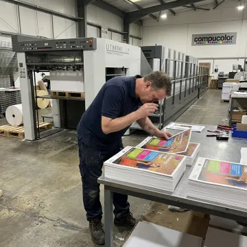 Operator reviewing printed marketing materials