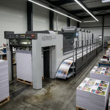 Modern offset printing press producing marketing materials