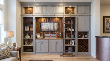 Custom built-in cabinetry with wine rack crown molding and coordinated hardware