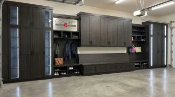 Custom garage mudroom cabinet system with lockers bench drawers and upper storage