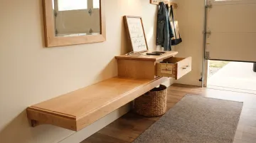 Welcoming garage mudroom entryway with mirror charging station and entry rug