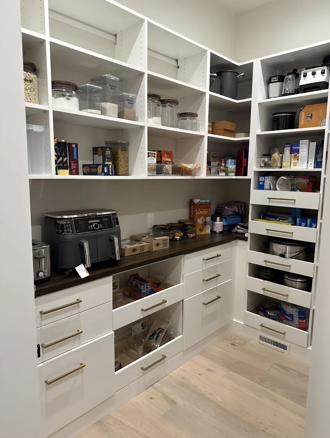 Designer measuring kitchen space for pantry cabinet installation