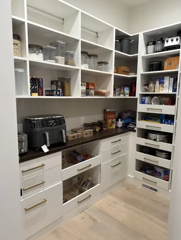 Designer measuring kitchen space for pantry cabinet installation