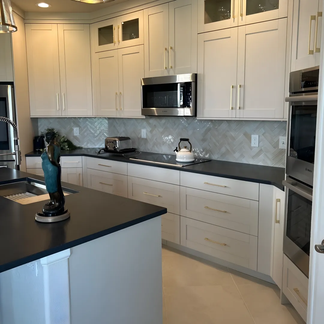 Designer reviewing custom kitchen plans with homeowners