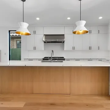 Designer reviewing kitchen remodel plans with homeowners