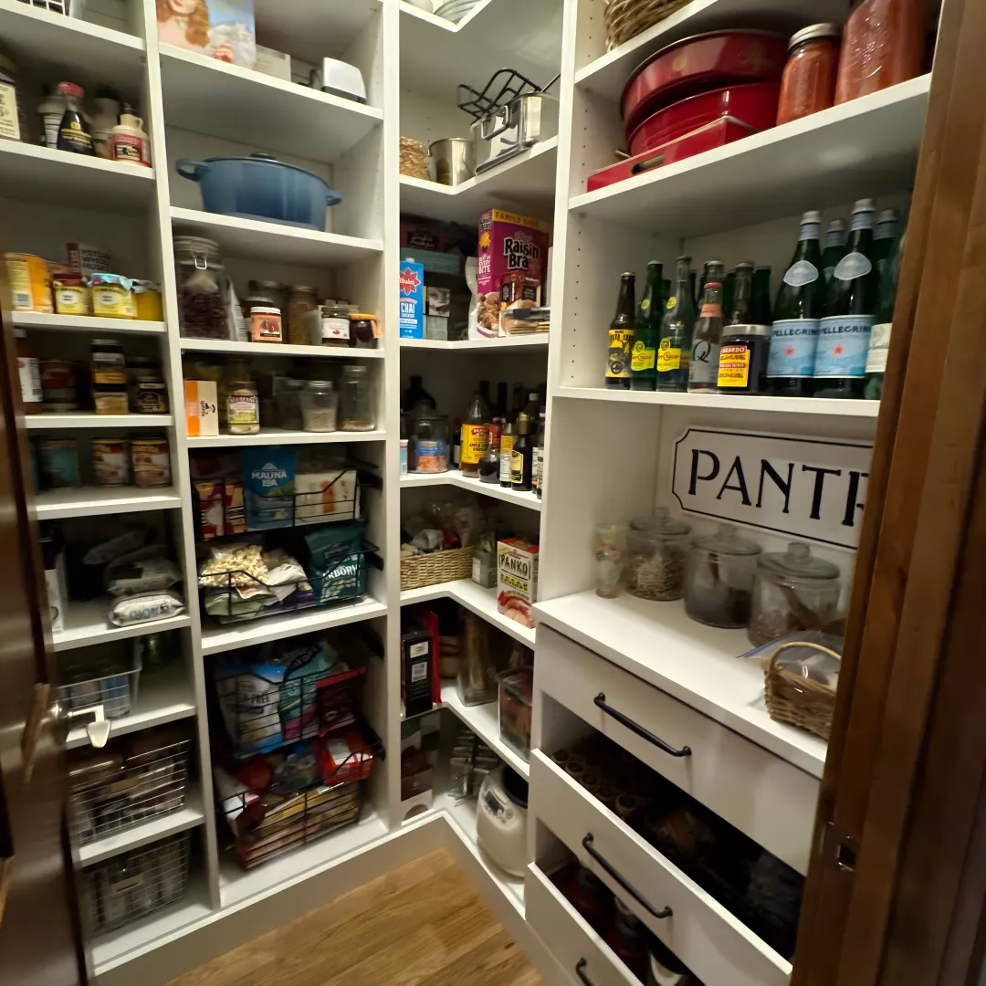 Designer measuring a pantry cabinet for pull-out shelves