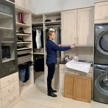 Designer reviewing laundry room cabinet plans
