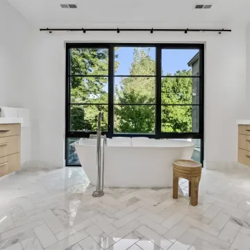 Designer measuring a custom bathroom vanity space