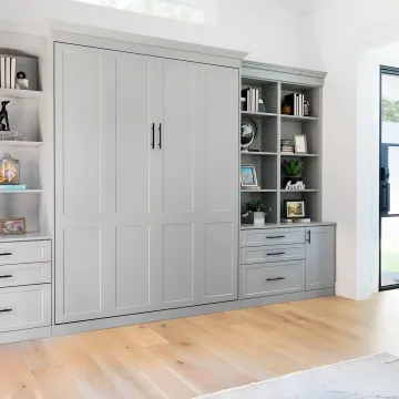 Installer measuring a room for a custom Murphy bed