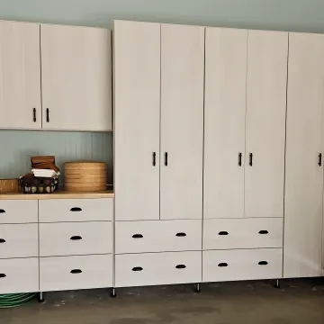 Designer measuring garage for custom cabinets