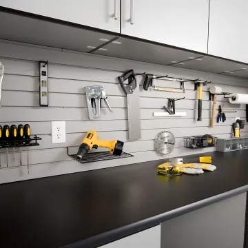 Designer reviewing custom workbench plans