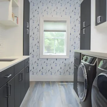 Designer reviewing laundry room cabinet plans