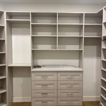 Designer measuring cabinetry for installation