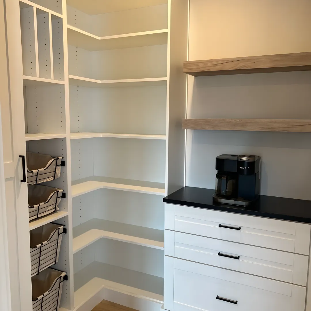Designer reviewing custom pantry plans with homeowner