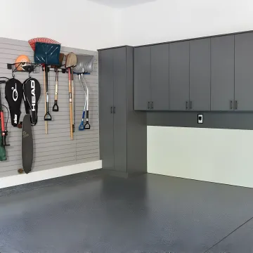 Designer measuring garage for custom cabinets
