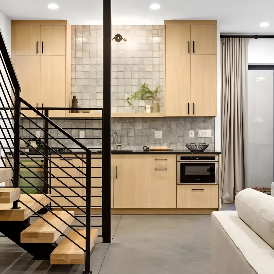 Cabinet designer measuring a living room alcove for built-in units