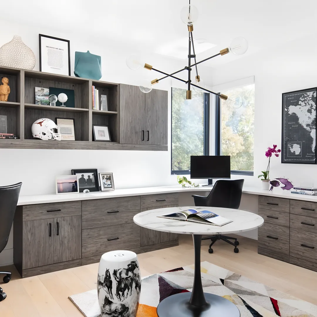 Designer measuring a home office for custom cabinets