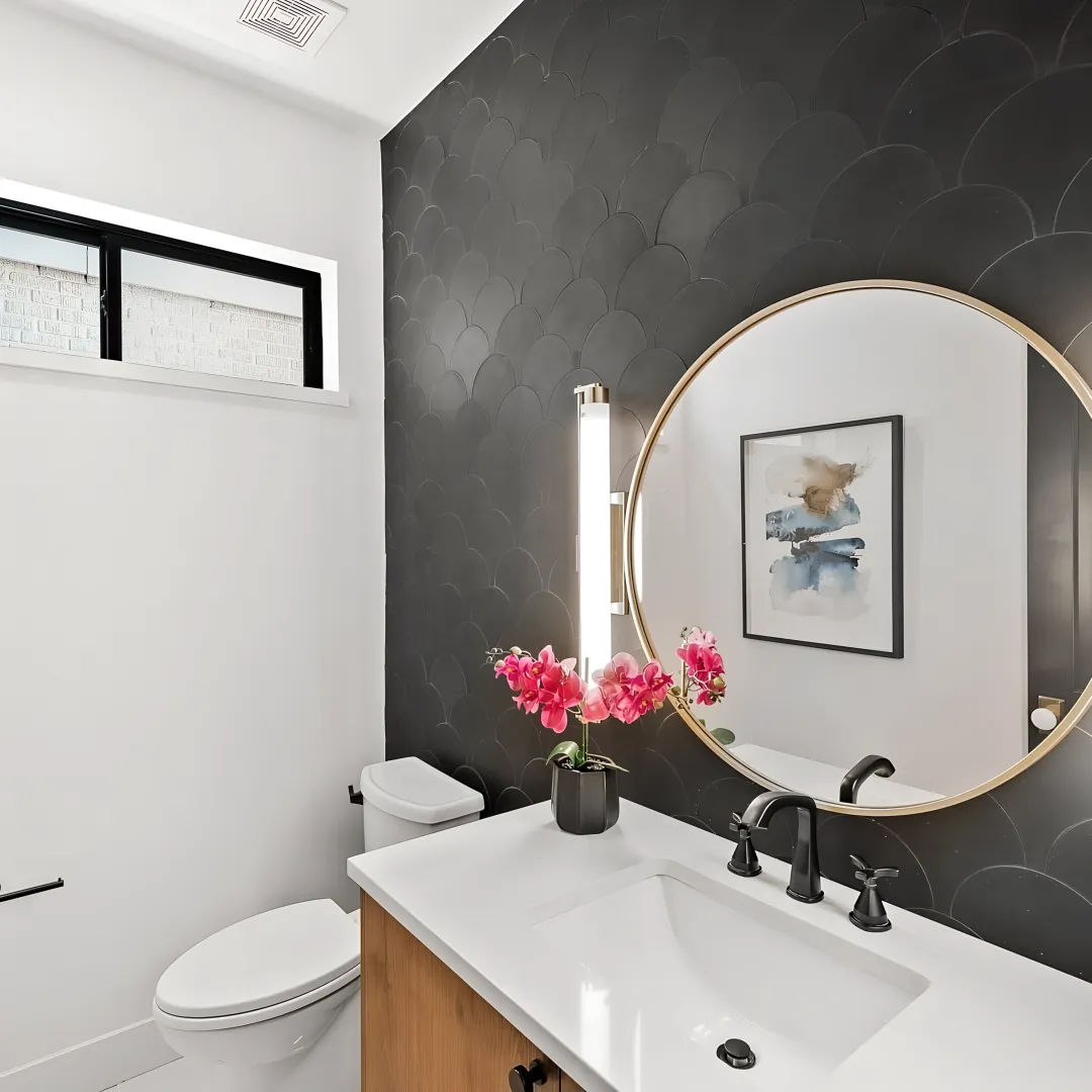 Designer measuring bathroom for custom cabinets