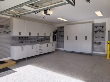 Custom garage adjacent mudroom cabinet system with lockers bench drawers and upper storage