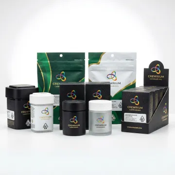 Turnkey cannabis packaging solutions including labeled containers, pouches, and custom display boxes arranged professionally