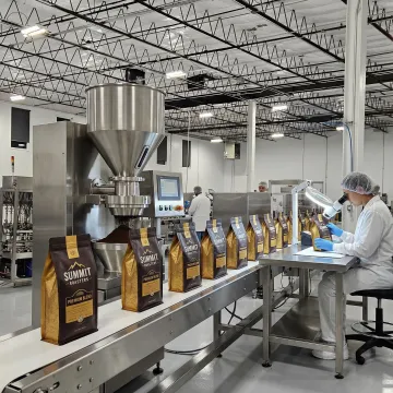 Coffee production line with custom branded packaging being filled