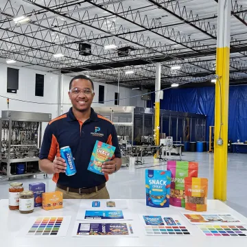 Co-packing team reviewing packaging designs and finished consumer products at a California facility