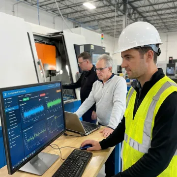 Engineer monitoring machine health data on industrial monitoring system dashboard