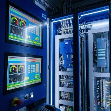 Industrial control system with PLC hardware and HMI interface in a manufacturing facility