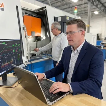 Engineer reviewing production monitoring software