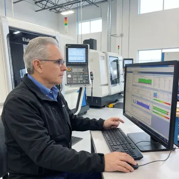 Engineer configuring production monitoring software