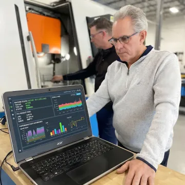 Engineer reviewing production tracking software data