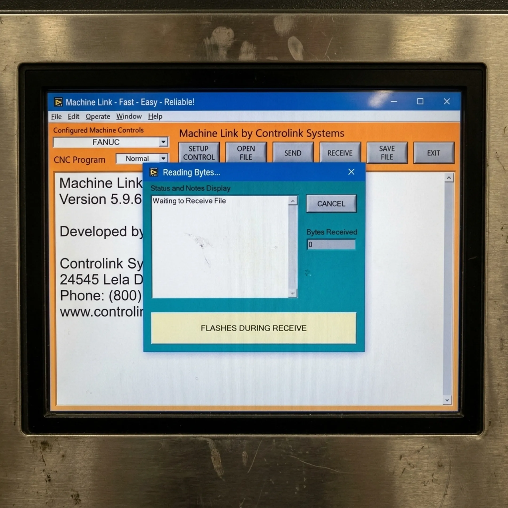 Machinist reviewing engineering-approved CNC program code at machine tool console