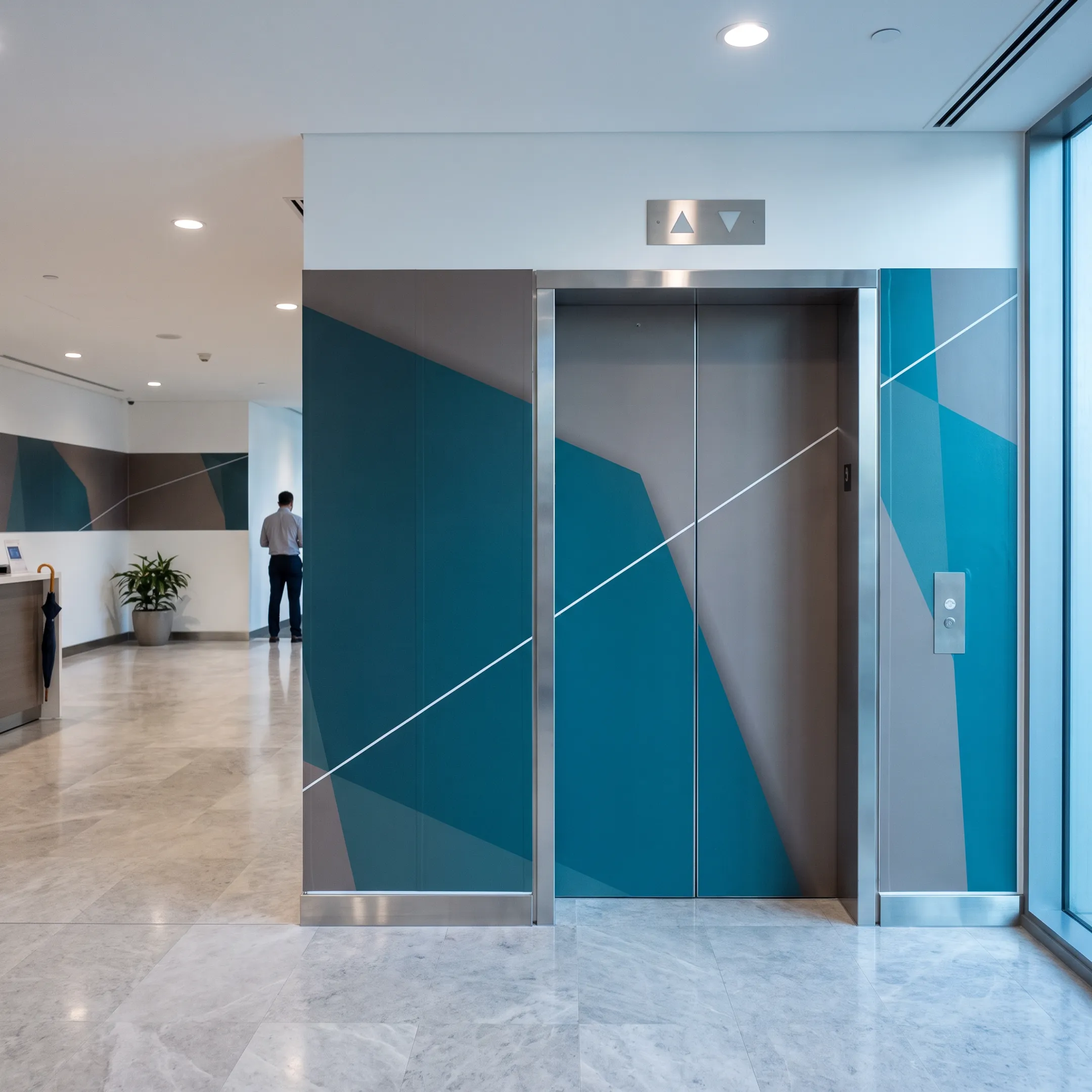 Branded vinyl elevator wrap displayed in a modern commercial lobby