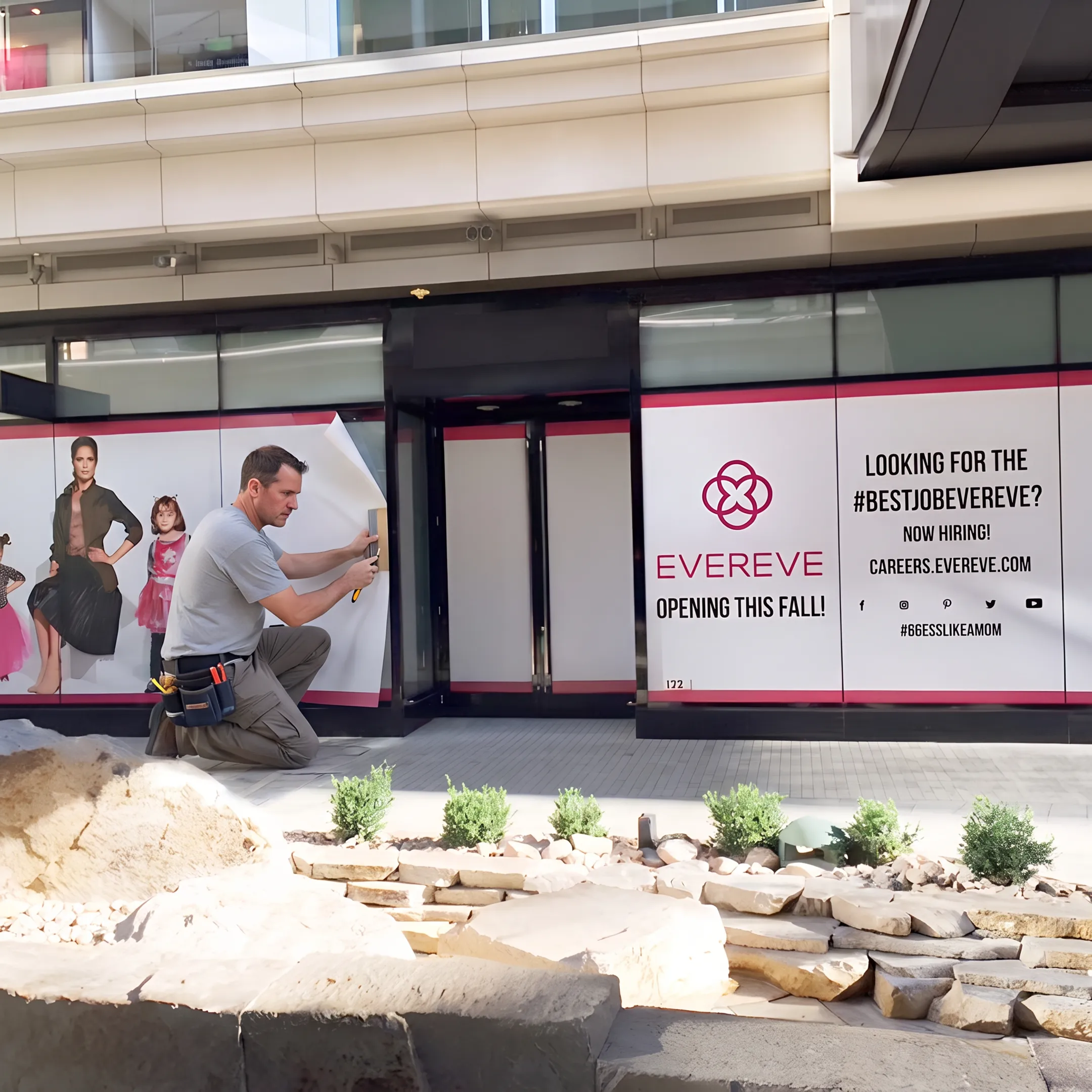 Installer applying branded window graphics to a commercial storefront