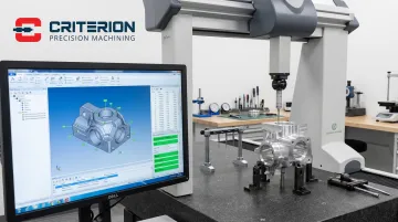 Precision CMM coordinate measuring machine inspecting tight-tolerance machined metal component