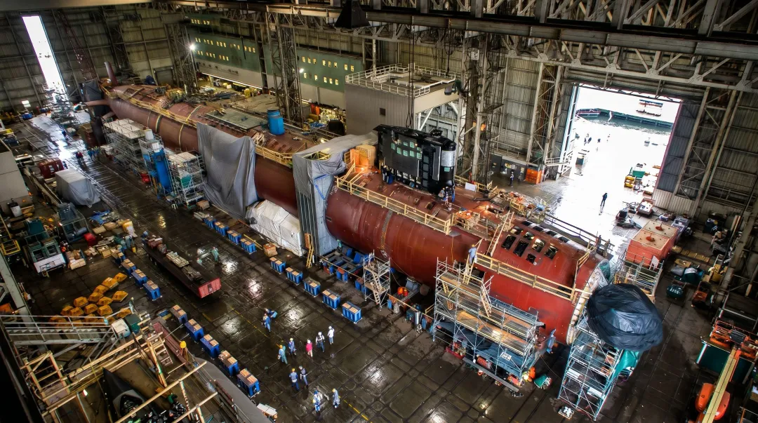 US Navy nuclear submarine under construction in large shipbuilding dry dock