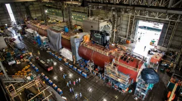 US Navy nuclear submarine under construction in large shipbuilding dry dock